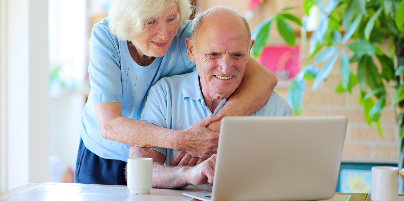 Eldery couple looking at laptop