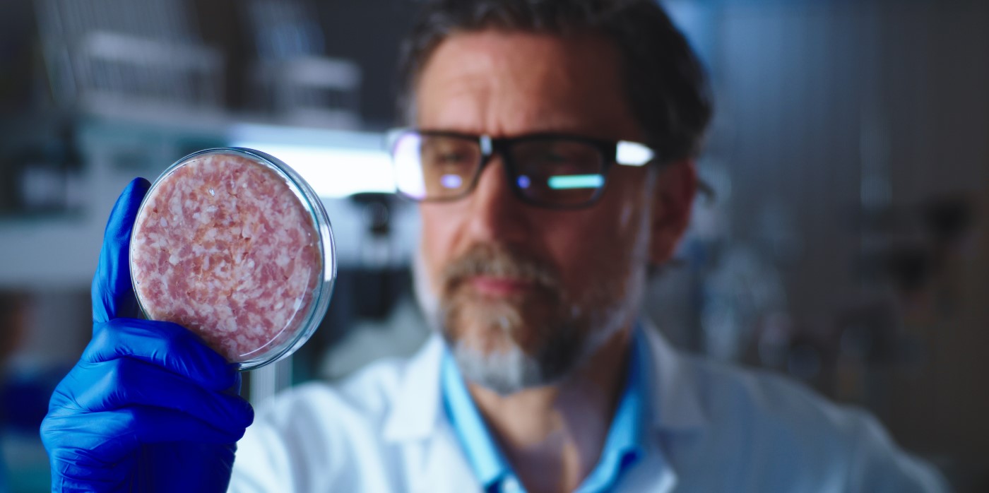 Scientist examining lab grown meat - Good Food Institute's Annual Call