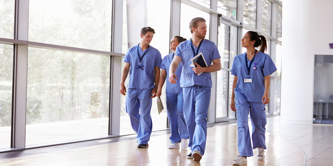 Group of healthcare professionals walking down corridor